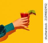 Small photo of Cheers. Woman's hand with bloody mary glass isolated on bright yellow neon background Concept of taste, alcoholic drinks. Complementary colors, blue, yellow and green. Pop art. Copy space for ad, text