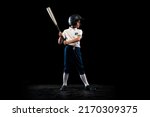 Small photo of Innings and outs. Dynamic portrait of little baseball player, pitcher in blue-white uniform training isolated on black studio background. Concept of sport, achievements, studying, competition.