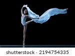 Small photo of Beauty. Graceful classic ballerina dancing with weightless cloth isolated on black studio background. Theater, art, grace, action and motion, ad concept. Artist of ballet in solo performance