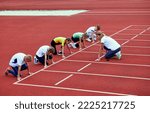 Small photo of Female coach training athletes. Start. Group of children preparing to run on treadmill at the stadium. Concept of sport, achievements, studying, goals, skills. Little boys and girls training outdoor.