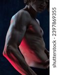 Small photo of Cropped image of beautiful male body, muscular torso, hands against dark studio background. Power, strength. Concept of men's beauty, health, body art and aesthetics, care, sportive lifestyle
