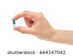 Beautiful female hand holds pill gesture. Isolated on white background