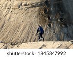 boy rides a bicycle in a sand pit