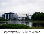 Small photo of Belfast, Northern Ireland - June 8 2022: Belfast cityscape with a view of a famous HW yellow crane and Titanic Museum