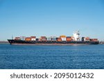 Small photo of CHARLESTON, SC, USA - DECEMBER 22, 2021: Constantinos P II, a 261-meter container ship owned by Baltic Shipping and flagged to the Marshall Island, sails into Charleston Harbor.