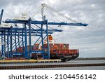 Small photo of CHARLESTON, SC, USA - JANUARY 09, 2022: Ship-to-shore cranes at Hugh K. Leatherman Terminal in Charleston Harbor load and unload the Hapag-Lloyd container ship Delaware Express.