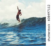Small photo of Surfer on the wave, catches a wave, surfing in the pipe. Surfing in the ocean on the island of Bali, a mellow man, a jump into the ocean