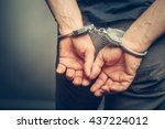 Male Hands In Handcuffs