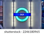 Small photo of LONDON, UK, 3RD December 2022: DLR roundel sign at a station at night