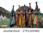 Small photo of Russia. Republic Tuva. Aydin-Bulak. Beautiful young women in national Tuvan clothes and headdresses in the ethnocultural complex on the territory of the Republic of Tuva Aldyn-Bulak - August 14, 20