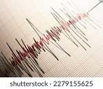 Small photo of Seismograph and earthquake. A seismograph that records the seismic activity of an earthquake.