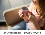 Young woman holding pink cup of ...