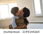 Soldier woman and boy hugging each other
