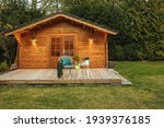 Wooden hut in spring. Drink tea in the garden when the weather is nice. Garden shed for vacation. Nice garden in Germany. 