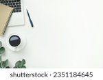 Small photo of Top view office table desk workspace frame with green leaves eucalyptus, notebook and coffee cup isolated on white background. Flay lay, ideas, notes or plan writing concept