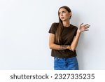 Small photo of Whats your problem. Arrogant snobbish young brunette in red t-shirt shrugging raise hands look with disdain and confusion, feeling questioned and bothered with strange accusation, white background