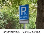 Parking place logo sign symbol in the woods. Parking sign. Parking reserve in the city. Mockup of a parking space. Space for text on the pillar of the park space. Travelling travel in the city.