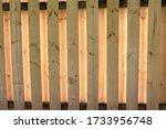 Small photo of Shadowbox fence with sunlight illuminating from behind, abstract background image.