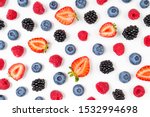 Strawberry, blueberry, blackberry, raspberry on white background, top view. Berries pattern, flat lay. Texture of fresh summer berries on white background. Creative food concept