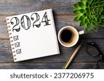 Small photo of New year resolutions 2024 on desk. 2024 resolutions list with notebook, coffee cup on table. Goals, resolutions, plan, action, checklist concept. New Year 2024 template, copy space