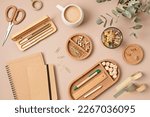 Flatlay of office supplies made of recycled materials on beige background. Flat lay, top view photo mock up.