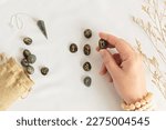 Small photo of Set of rune stones for divination and fortune telling. Mystic still life with labradorite runes. Esoteric, occult , witchcraft rituals idea