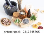 Small photo of Botanical blends, herbs, essencial oils for naturopathy. Natural remedy, herbal medicine, blends for bath and tea on wooden table background
