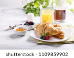 Breakfast served with croissants, coffee, orange juice and berries. 