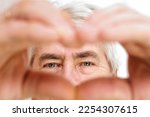 Happy Old Senior Man Making Heart Shape Hand Gesture. Look at Camera, Showing Romantic. Retired Elderly Grandparent Close Up Portrait. Symbol of Love Yourself. Doing charity Work, take Care of Health.