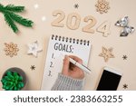 Small photo of New Year Aims 2024. To Do List. Empty Notebook at the Desk with Holiday Decoration. Top view. Creating Plan, Resolution. New Life, Start Up, Beginning Concept. Business ideas. Goals, action, checklist