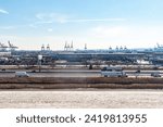 Small photo of Port of Newark, New Jersey, USA - March 1, 2023: Aerial view of the New Jersey Turnpike with the Port of Newark - Elizabeth Marine Terminal and Panamax Cranes in the background.
