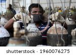 Small photo of New Delhi, India, April 21, 2021: Worker refilling medical oxygen cylinder for Covid-19 infections patients at a gas supplier filling station during the second wave of coronavirus Covid-19 pandemic.