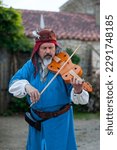 Small photo of Bazoges-en-Pareds, France - July 29 2017: A medieval minstrel playing violin during the annual 'Nocturnes Medievales' festival.
