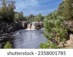 Small photo of Beautiful Fall at Richmond Fall, on river Swale in Yorkshire, taken on a sunny summer day. Blue sky, waterfall, river flowing, surrounded by trees and nature.