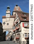Small photo of Rothenburg ob der Tauber, Germany - June 17, 2022: Markus Tower, the Roeder Arch and the Romantik Hotel Markusturm in the medieval City of Rothenburg ob der Tauber. Upright Format.