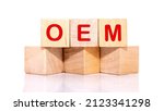 Small photo of OEM abbreviation of original equipment manufacturer text on wooden cubes on a white background.