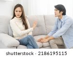 Small photo of Breakup and depressed, quarrel asian young couple love fight relationship in trouble, wife face expression upset with husband, boyfriend want to reconcile, promise his girlfriend. Problem of family.