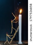 Small photo of Matchsticks in form of a man lighting a candle, matchstick man lighting a candle with smoke.