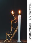 Small photo of Matchsticks in form of a man lighting a candle, matchstick man lighting a candle.
