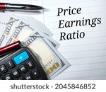 Small photo of Business concept.Text Price Earnings Ratio writing on notebook with pen,calculator and banknote.