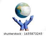Small photo of World Epidemic Danger. World need protect the earth globe with a face mask and hands, isolated on a white background. Human Epidemic Danger. Earth globe with Hungarian text.