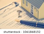 Small photo of Business legal document concept : Pen, key, a house on a lease agreement form. Lease agreement is a contract between a lessor and a lessee that allow lessee rights to use of a property owned by lessor