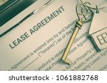 Small photo of Business legal document concept : Pen and a keychain on lease agreement form. Lease agreement is a contract between a lessor and a lessee that allow lessee rights to use of a property owned by lessor.