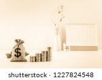 2021 Calendar schedule for long term fund invest, pension saving, financial concept : US dollar bag, coins and clock, depicts time value of money, investing ways to beat high inflation with growth