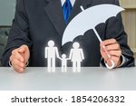 Small photo of Family life insurance, financial security concept : Businessman protects family members e.g parents and a child, depicts protection from insurer who will pay a lump sum for clearing burden of debt