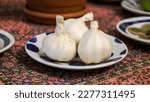 Small photo of Garlic symbol in Nowruz table. garlic in Norooz setting. Haft sin in Norouz haft seen table. Persian new year