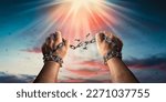 Small photo of Hands in fists breaking a chain freedom. The concept of gaining freedom.