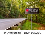 Welcome to Virginia sign located at the Maryland, Virginia state border at Purcellville, Virginia. The black sign has a red heart shape and 