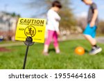 A yellow yard sign warning kids ...