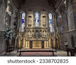 Small photo of Bamburgh, Northumberland, England, UK. May 6, 2023. The large and delicate decorative screen or reredos behind the alter in St. Aidan's Parish Church.